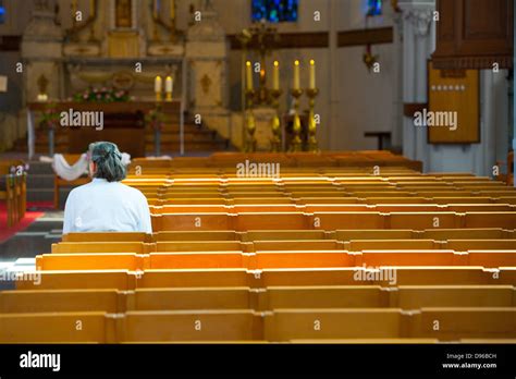 People Sitting And Praying Inside A Christian Church In Europe Stock