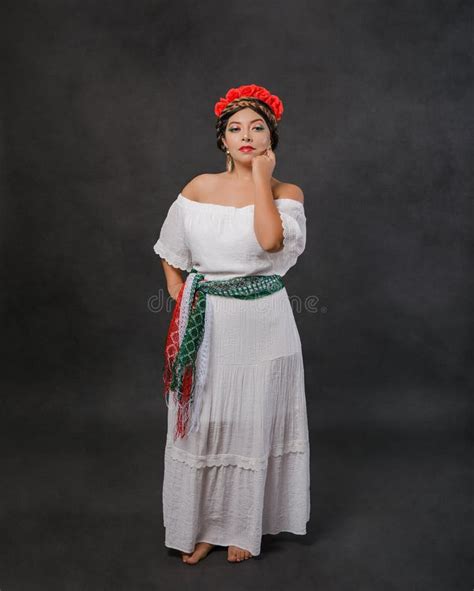 Mexican Woman With White Dress And Scarf With The Colors Of The Mexican