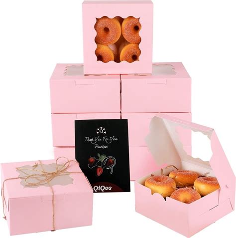 pink boxes filled with donuts next to each other