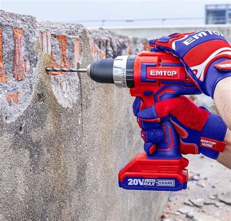 A Man Is Using A Drill To Fix A Brick Wall With A Power Tool On It