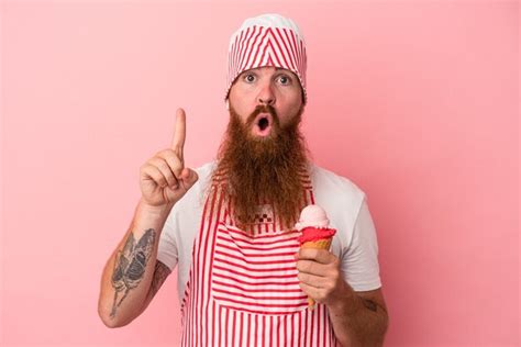 Premium Photo Young Caucasian Ginger Man With Long Beard Holding An