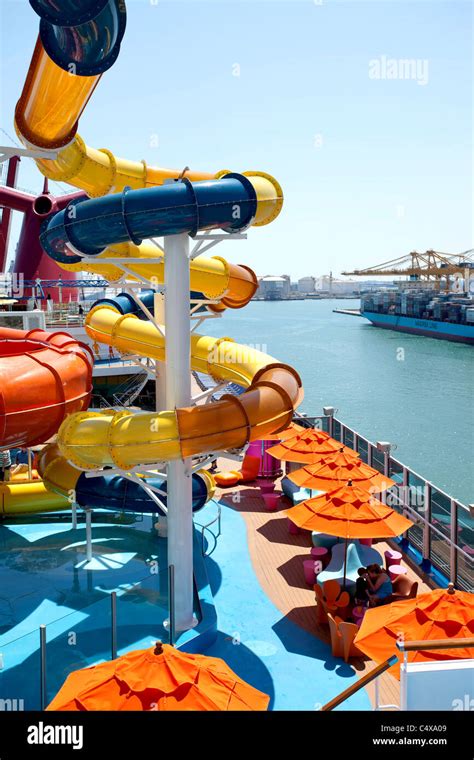 Cruise ship water park and recreation. Water slides, pools and splash fun. Passengers walking ...