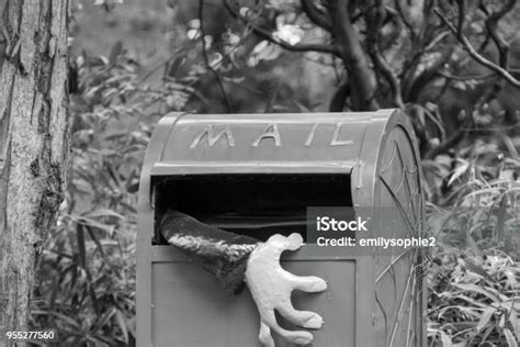 Creepy Black And White Ghoulish Hand Reaching Out From Mailbox Stock