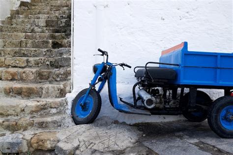 Premium Photo Motor Scooter On Footpath Against Wall