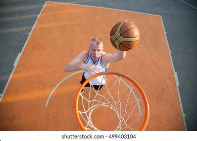 Basketball Street Player Making Slam Dunk Stock Photo