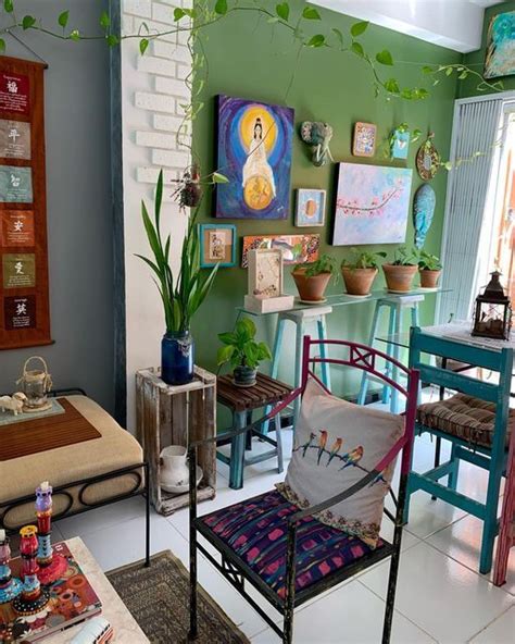 A Living Room Filled With Furniture And Paintings On The Wall