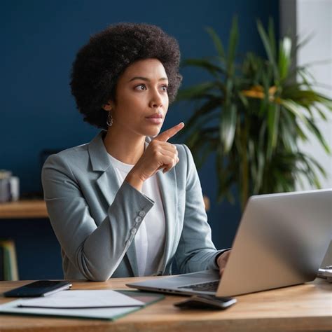 Premium Photo A Woman Sits At A Desk With A Laptop And A Laptop On