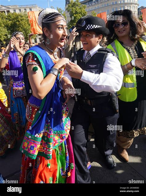 A Police Officer Dances With Members Of The Public During The Diwali On