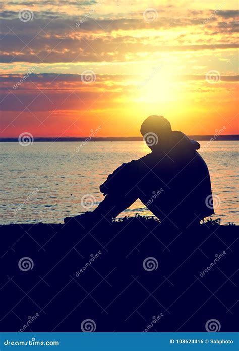 person  sunset silhouette stock photo image  lonely meditate