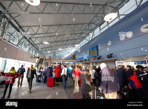 passengers queuing at check in desks in Tromso airport troms Norway ...