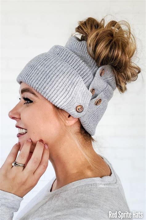 A Woman Wearing A Gray Knitted Beanie With Buttons On The Front And Side