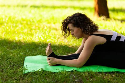 Beautiful European Woman In Park Doing Yoga Exercises Protects Health Calm And Tranquility