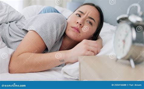 Couple Sleep And Alarm Clock In Bedroom With Wake Up Sound Makes Annoying Noise In The Morning