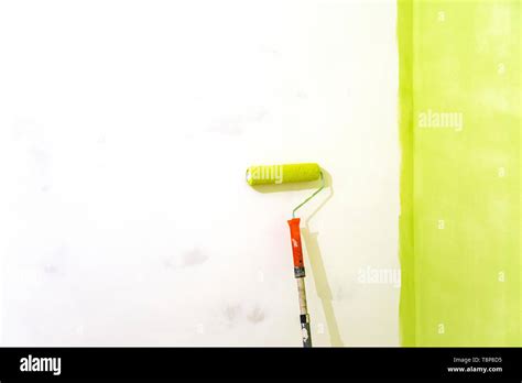 Wall painting green color and copy space. Painting a house wall with a ...