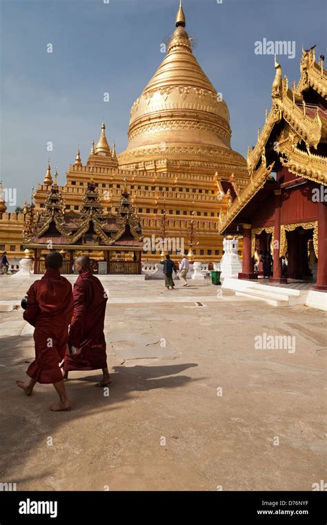 Two Monks Walking At The Shwezigon Pagoda In Bagan Myanmar Stock Photo