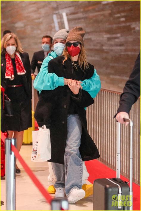 Justin And Hailey Bieber Cuddle Up In The Airport While Leaving Paris