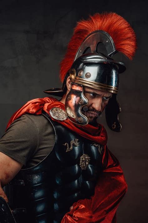 Serious Roman Emperor Dressed In Dark Armour And Red Cloak Stock Photo