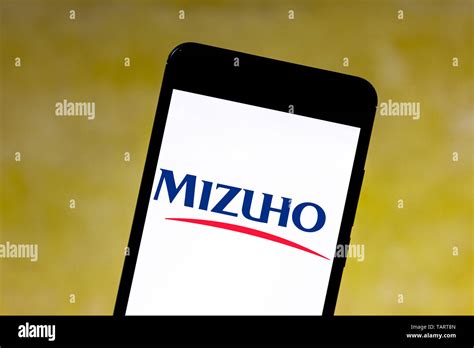 In this photo illustration the Mizuho logo is seen displayed on a ...