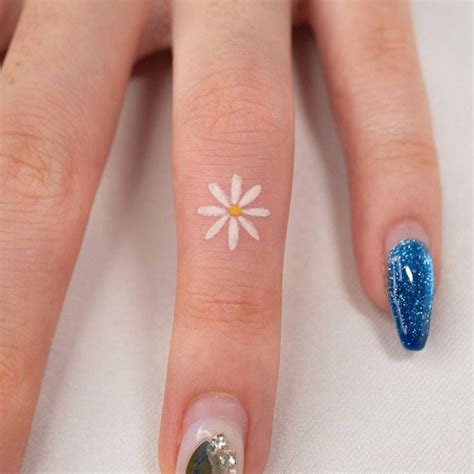 Minimalist Daisy Flower Tattoo On The Finger Flower Finger Tattoos