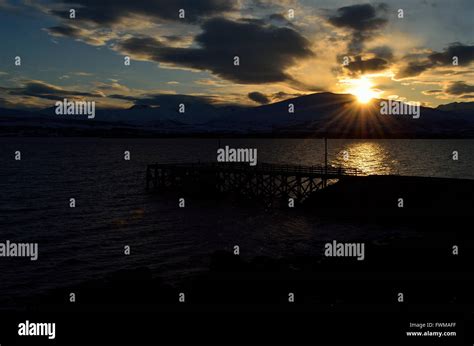 Beautiful Sunset Over Snowy Mountain Fjord And Pier Stock Photo Alamy