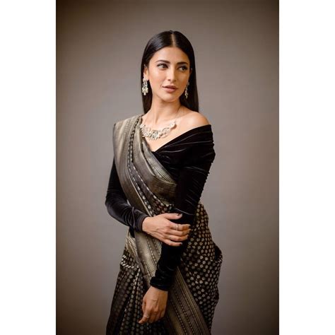 In A Black Color Saree And Velvet Off Shoulder Full Sleeve Blouse