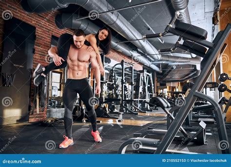 Strong Bodybuilder Carrying Girlfriend On Shoulders During Training