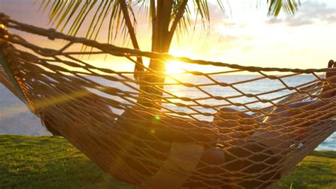 Romantic Couple Relaxing In Tropical Hammock At Sunset Summer Luxury