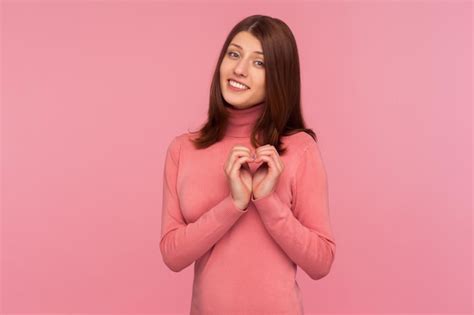 Premium Photo Cute Pretty Brunette Woman In Pink Sweater Showing