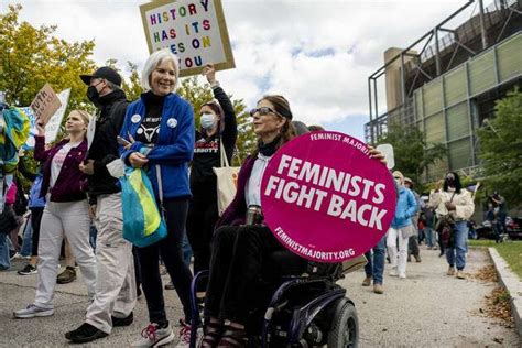 Womens Wave March 2022 Demonstrators Hold Signs During The Womens March