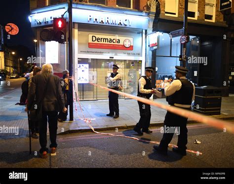 Police Officers At The Scene On Upper Street In Islington Hi Res Stock