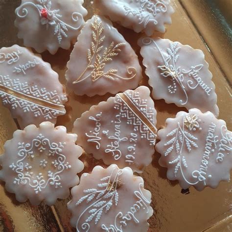 Some Cookies Are Decorated With White Frosting And Decorative Designs