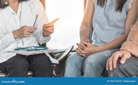 Patient Couple Consulting With Doctor Or Psychologist On Marriage