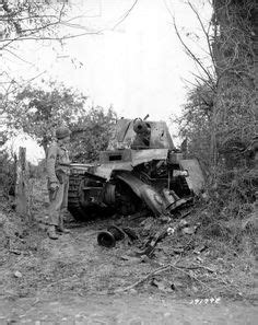 A destroyed German Wespe SP, Self-Propelled artillery, gets the once over by an American ...