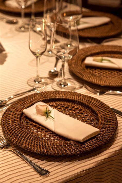 A Table Set With Place Settings And Wine Glasses