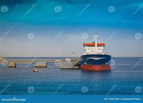 Small Tanker Ship Bringing Its Cargo In A Tank Storage Facility Stock