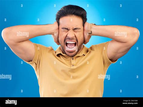 Man Covering His Ears While Screaming In A Studio For Angry Upset Or