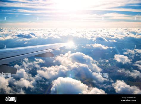 plane wing with beautiful white clouds in background at sunset Stock ...