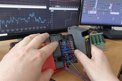 An Electrical Engineer Adds A New Io Card To A Modular Plc Automaton