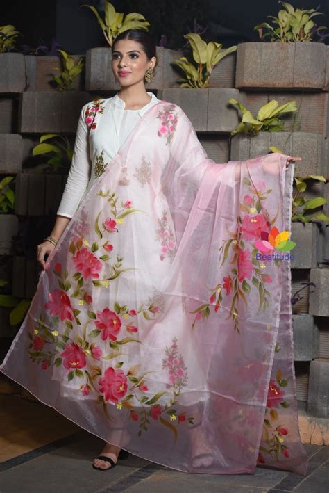 A Woman Wearing A White And Pink Floral Print Sari With Matching Dupatta