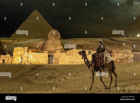 Giza pyramids and Sphinx light up at night Stock Photo - Alamy