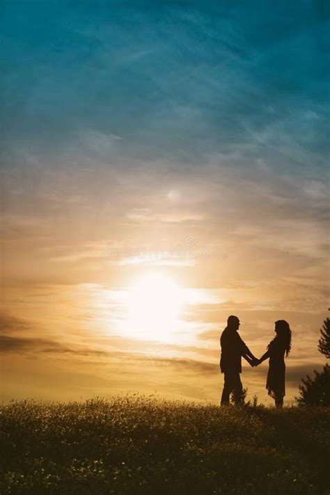 Silhouette Of A Happy Loving Couple At Sunset Stock Photo Image Of