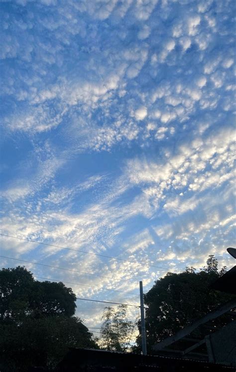 the sky is filled with clouds and trees