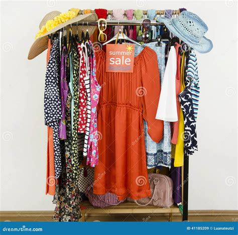 Cute Summer Outfits Displayed On Hangers With A Big Sale Sign Stock