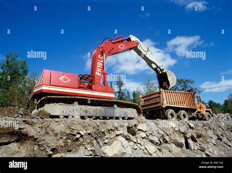 Excavator Loading Dump Truck Stock Photo Alamy