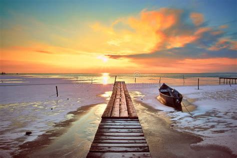 Sunrise on the Lake with Wooden Boats in Winter 3 Stock Photo - Image ...