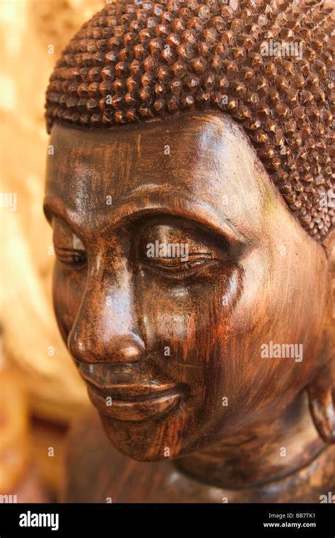 A Wooden Buddha Sits In A Shrine On The Grounds Of The Silver Pagoda In