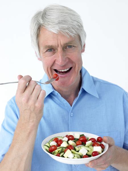 Smiling man eating salad Free Photo Download | FreeImages