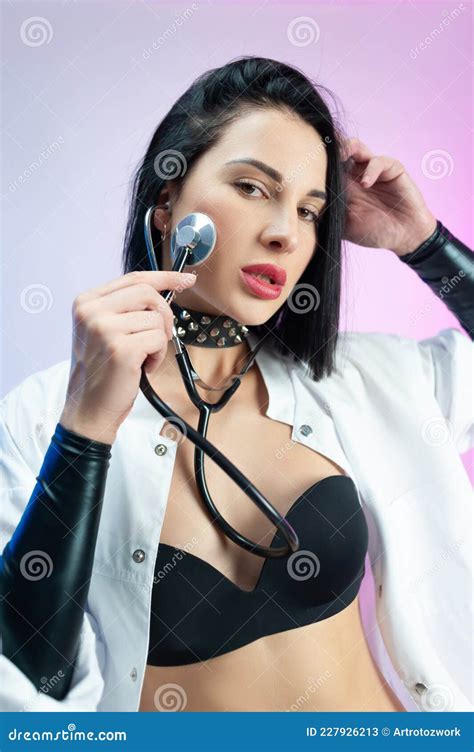 Portrait Of A Female Doctor In Underwear And A White Coat With A