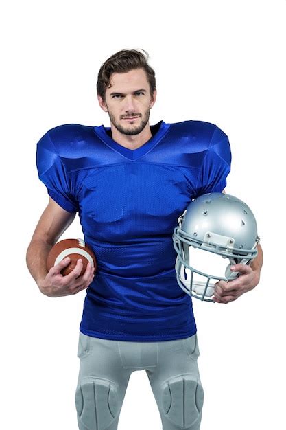 Premium Photo American Football Player Holding Helmet And Ball