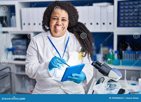 African American Woman Scientist Smiling Confident Writing On Touchpad